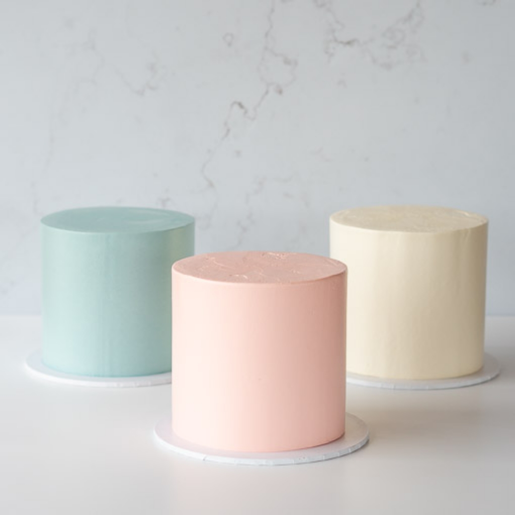 plain buttercream cake in 3 colours blue pink cream