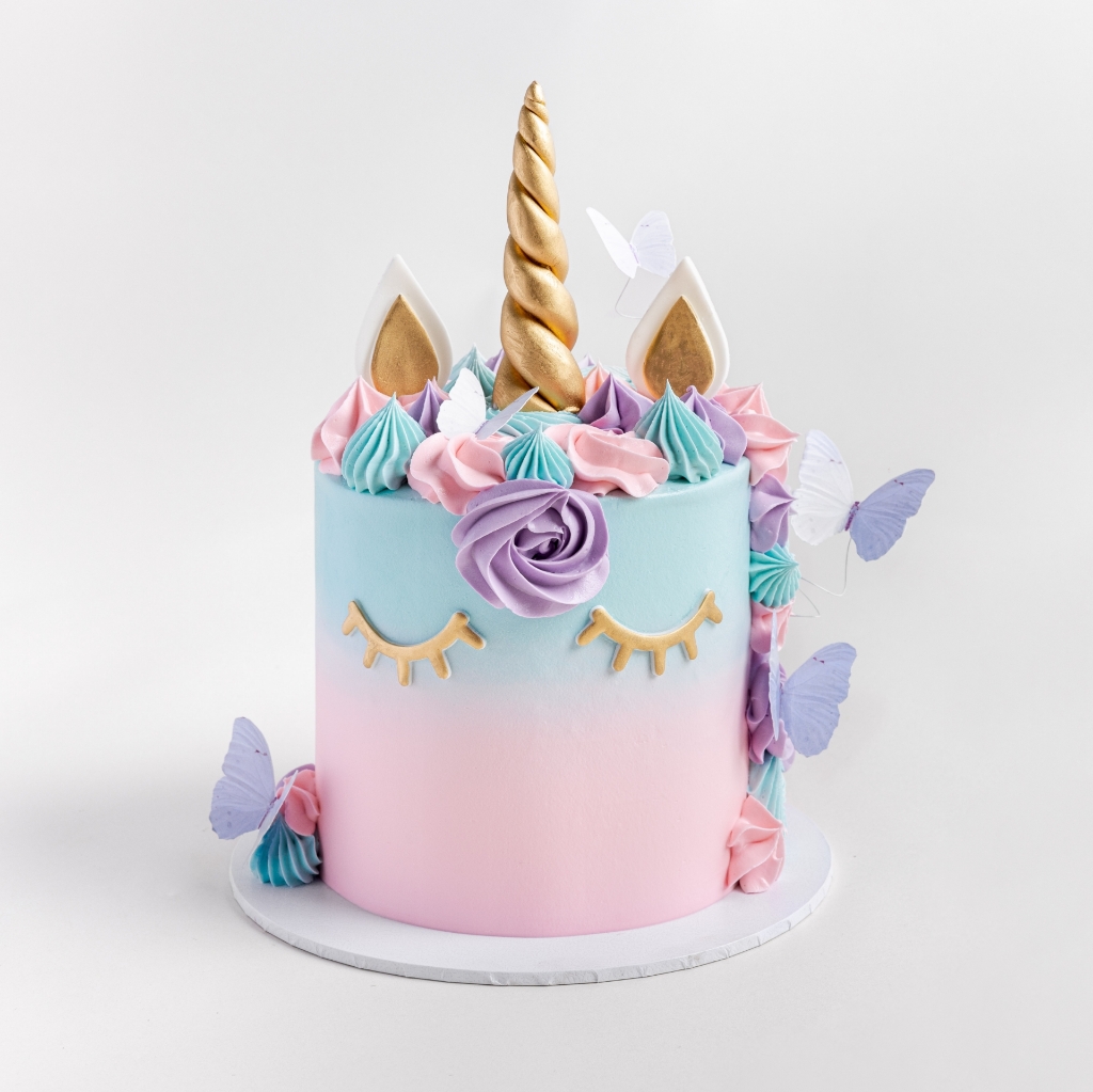 Magical unicorn buttercream cakes with gold horn, ears & colourful mane.