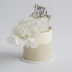 A sophisticated two-tone buttercream cake with a creamy white top half and a light beige bottom half, featuring an uneven, organic line where the two colors meet. The cake is lavishly decorated with a large cluster of fresh white phalaenopsis orchids cascading down one side.