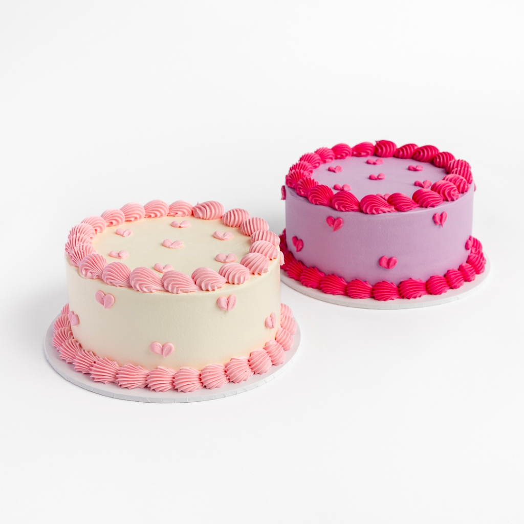 Two Mini Hearts Buttercream Cakes, one cream with pink hearts and one purple with pink hearts