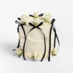 White buttercream cake with black ribbon bows and white roses