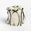 White buttercream cake with black ribbon bows and white roses