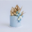 Modern buttercream cakes in pastel blue, topped with a stunning fancy faux floral arrangement of gilded palm spears and macarons.