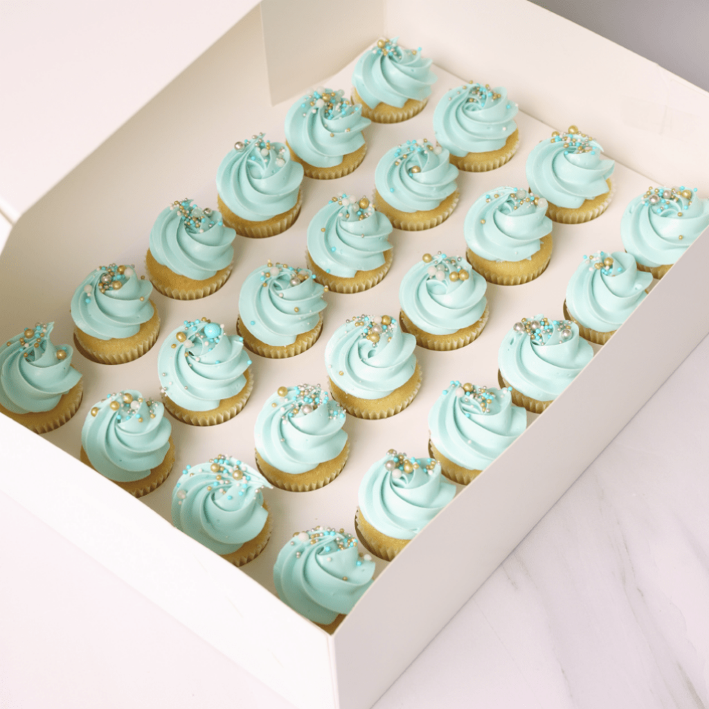 mini vanilla cupcakes with blue frosting and spinkles